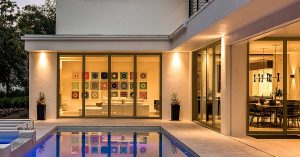 Impact-resistant sliding patio doors open onto a Florida patio with a pool.